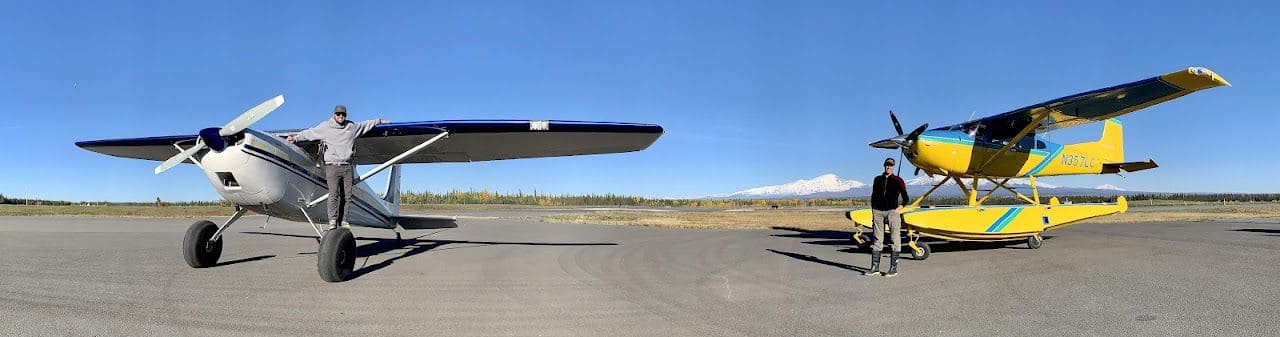 Two small planes on an airfield.