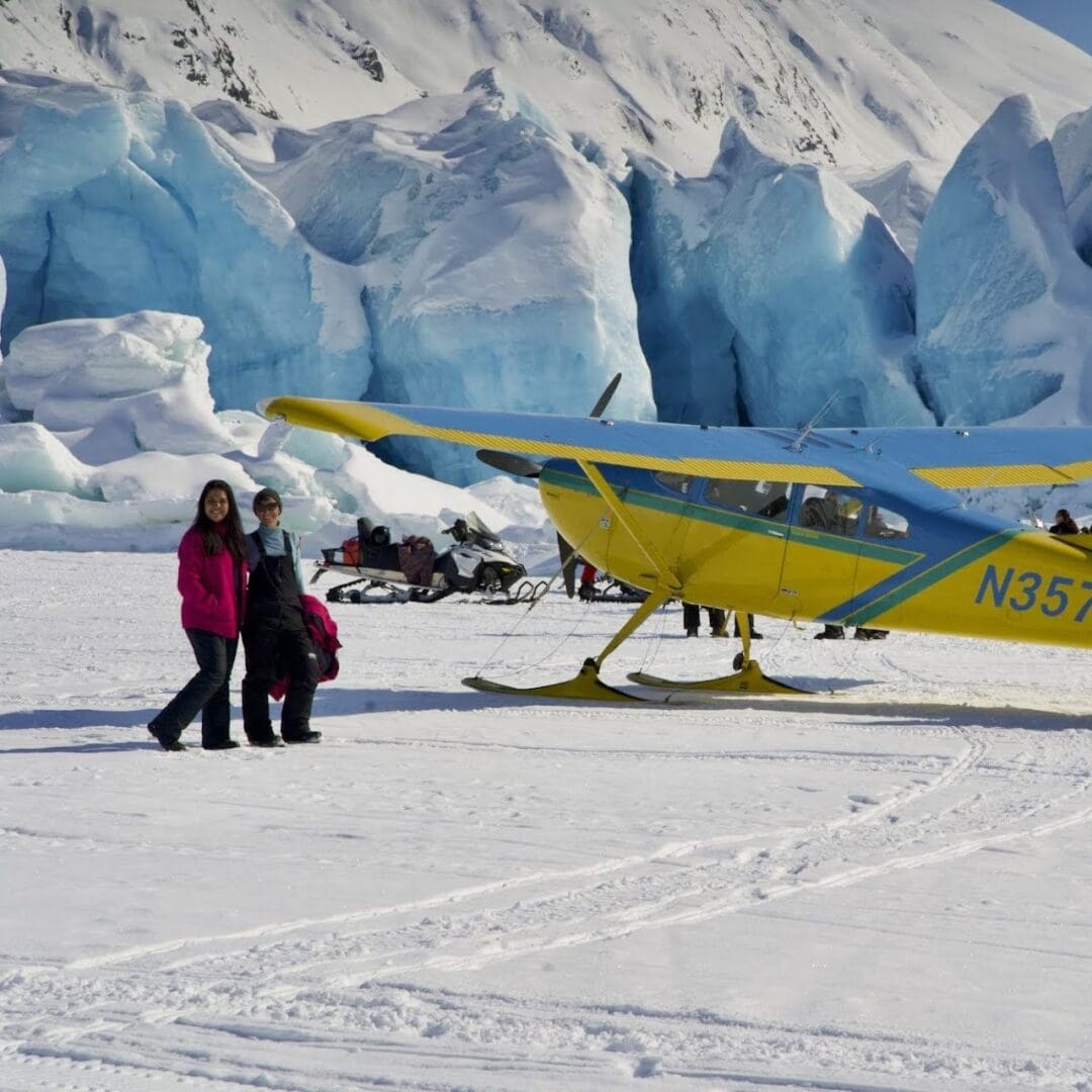 Small plane on snowy glacier landscape.