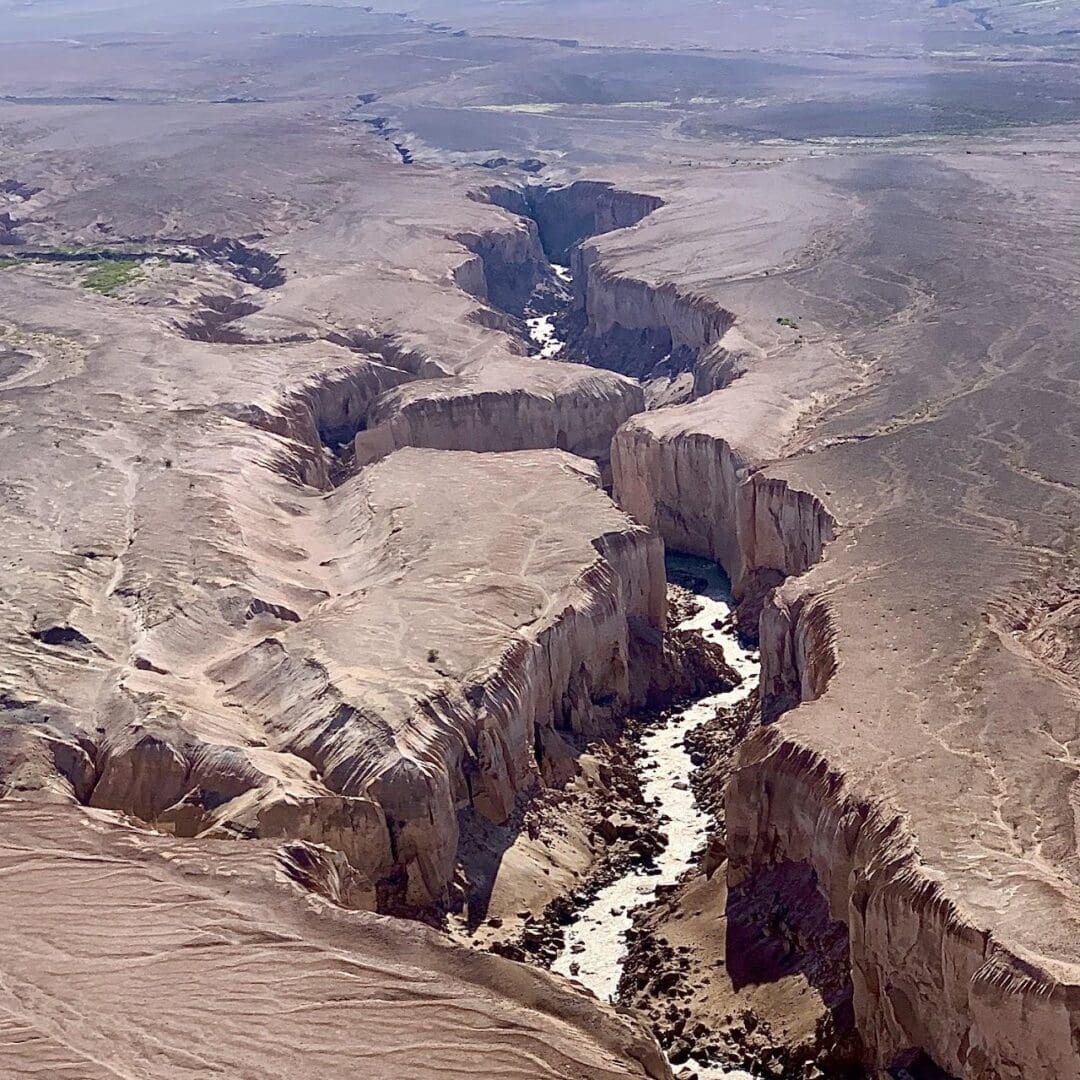 Desert canyon with winding river view.