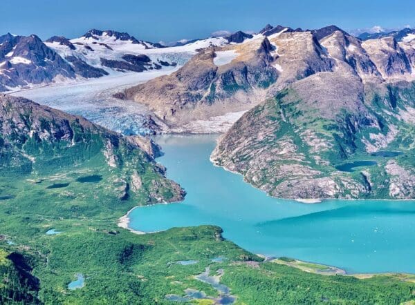 Mountain landscape with glacier and turquoise lake.