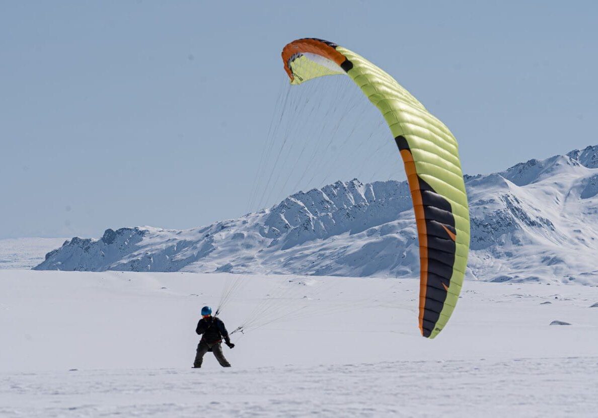 _DSC7466-Enhanced-NR Person snowkiting on snowy mountain landscape.